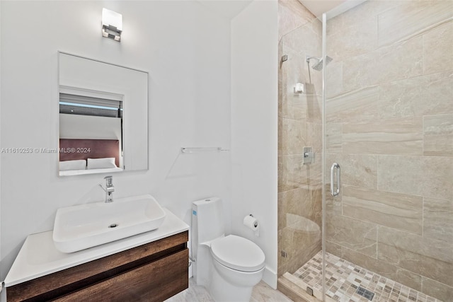 bathroom featuring vanity, toilet, and a shower with shower door