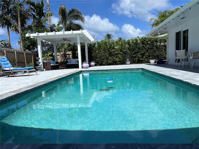 view of swimming pool featuring an outdoor living space, a patio, ceiling fan, and a pergola