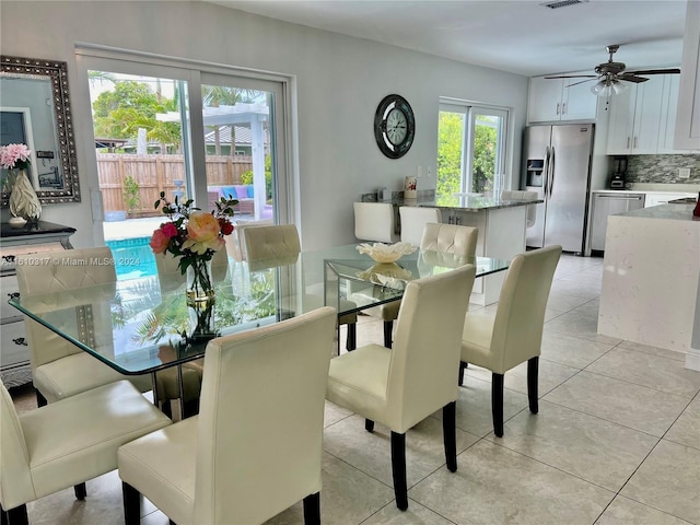 tiled dining area featuring ceiling fan