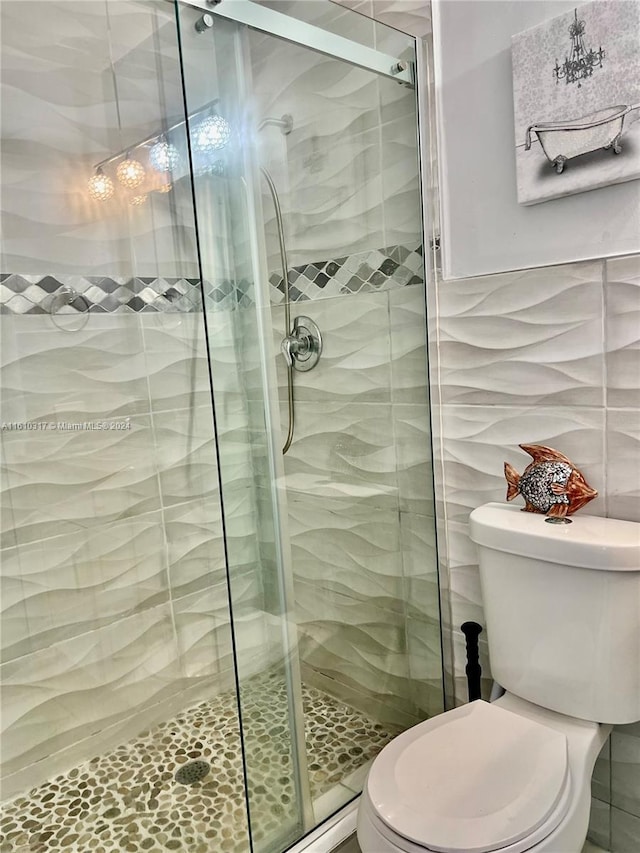 bathroom with toilet, tile walls, and walk in shower