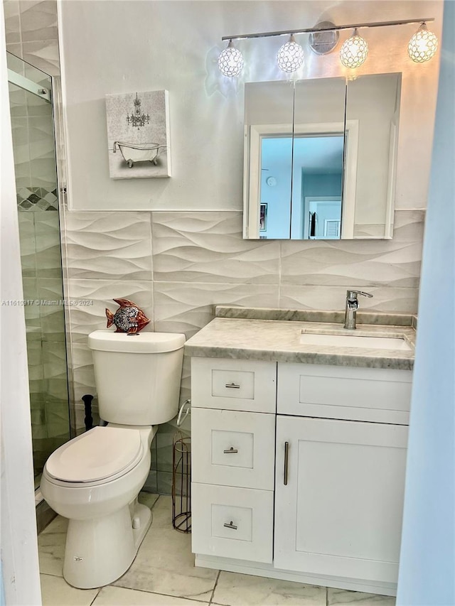 bathroom with decorative backsplash, vanity, a shower with door, tile walls, and toilet