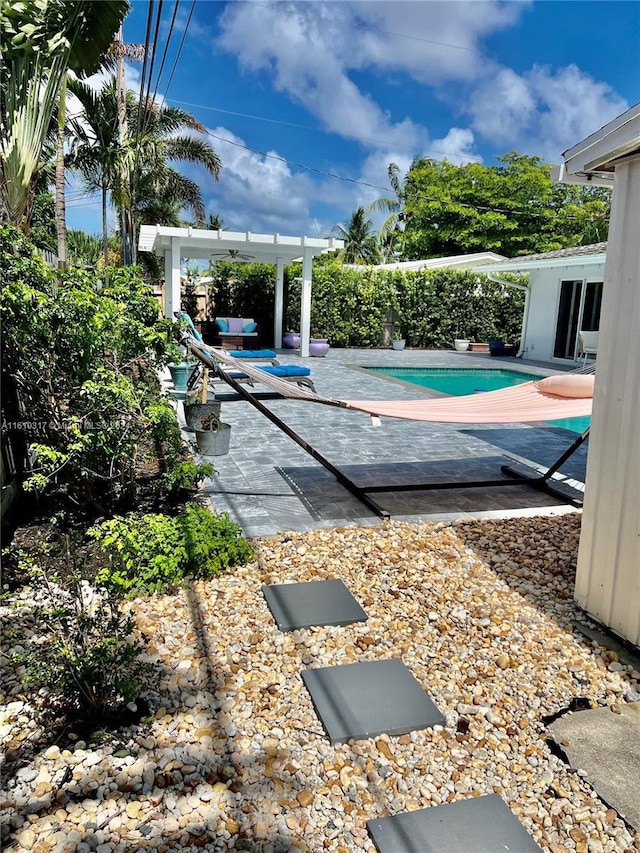 view of swimming pool featuring a patio area and a pergola