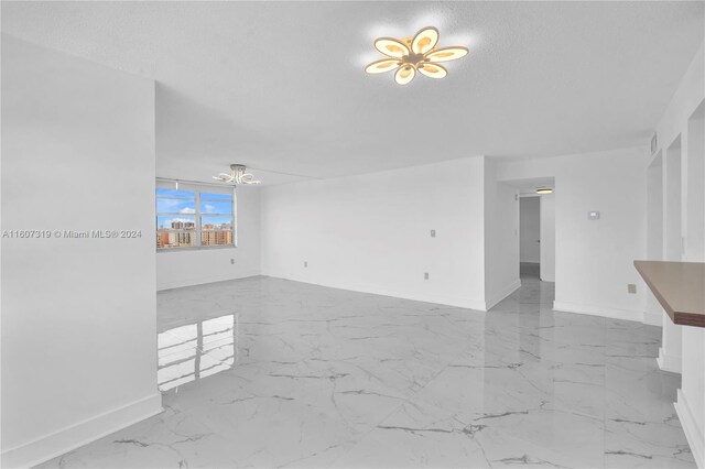 tiled empty room with a textured ceiling