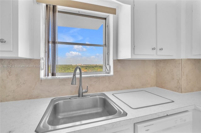 kitchen with sink, white cabinets, backsplash, and dishwasher