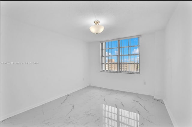 empty room with a textured ceiling