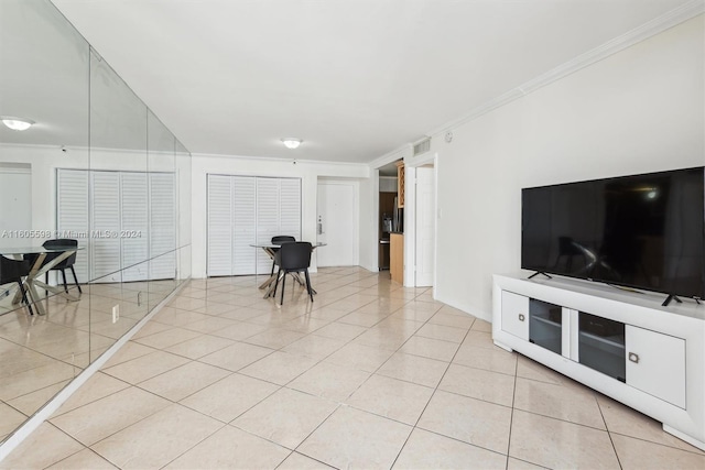 living room featuring light tile patterned flooring and ornamental molding