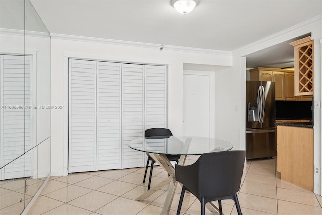 dining area featuring light tile patterned flooring and ornamental molding