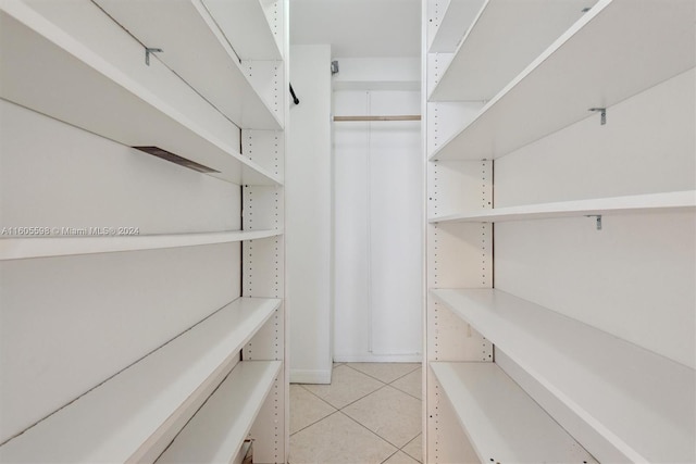 spacious closet featuring light tile patterned flooring