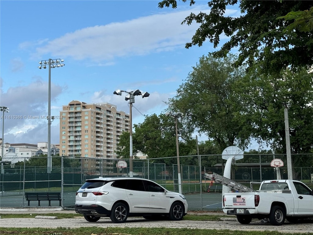 view of car parking with basketball hoop