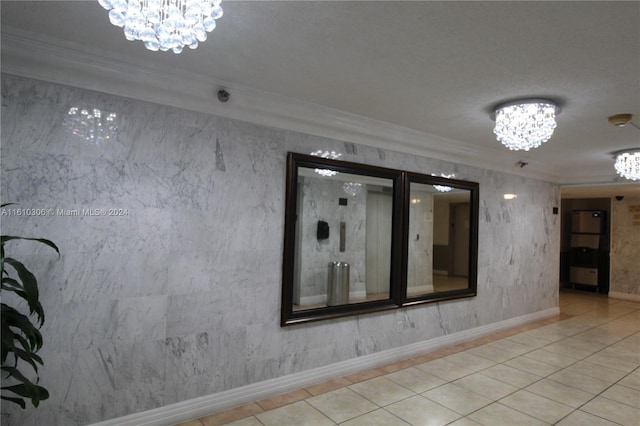 tiled spare room with a textured ceiling, a notable chandelier, and crown molding