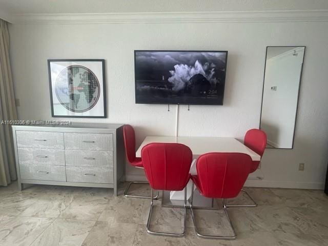 dining area featuring crown molding