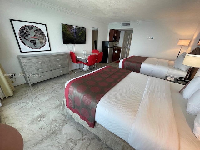 bedroom with ornamental molding, a textured ceiling, and stainless steel refrigerator