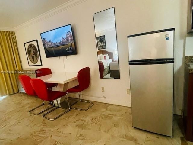 dining space featuring ornamental molding