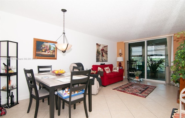 dining room with light tile patterned floors and a textured ceiling