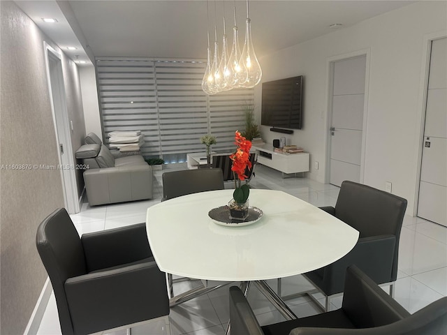 dining room featuring light tile patterned floors and an inviting chandelier