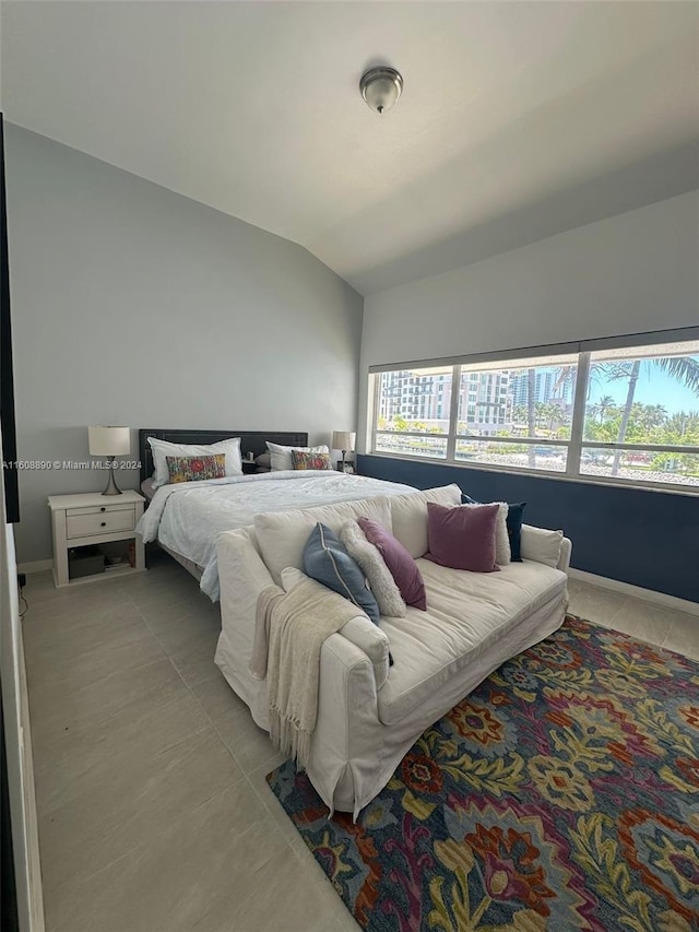 330 Poinciana Dr Unit 1002, Sunny Isles Beach, FL 33160 - bedroom with vaulted ceiling, light tile patterned flooring, and baseboards