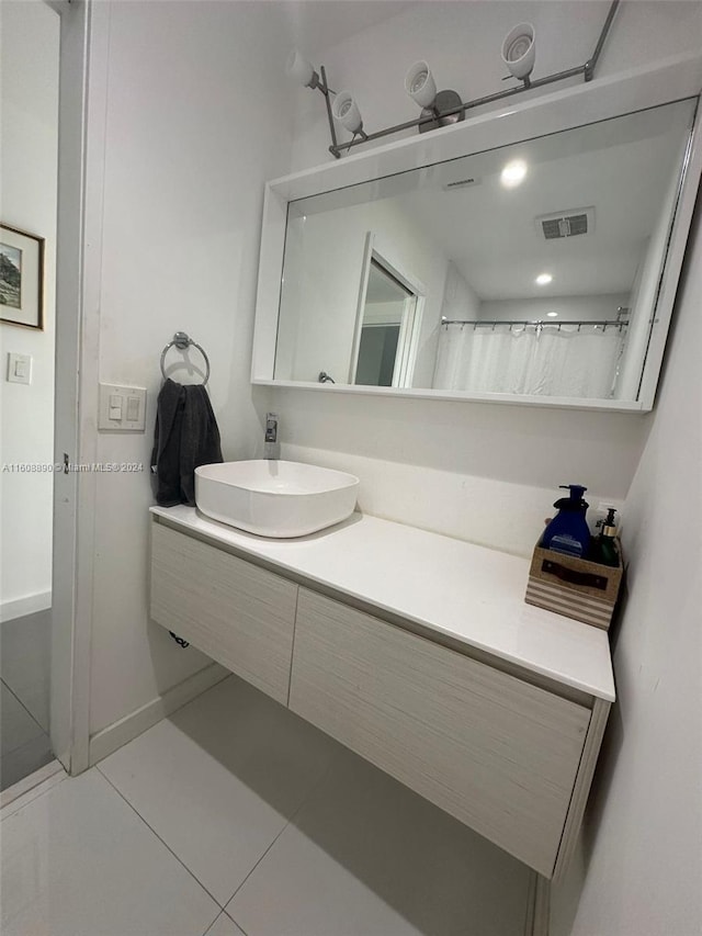 bathroom with tile patterned flooring and vanity