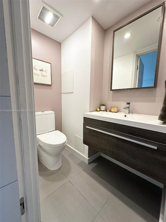 bathroom featuring tile patterned floors, toilet, and vanity