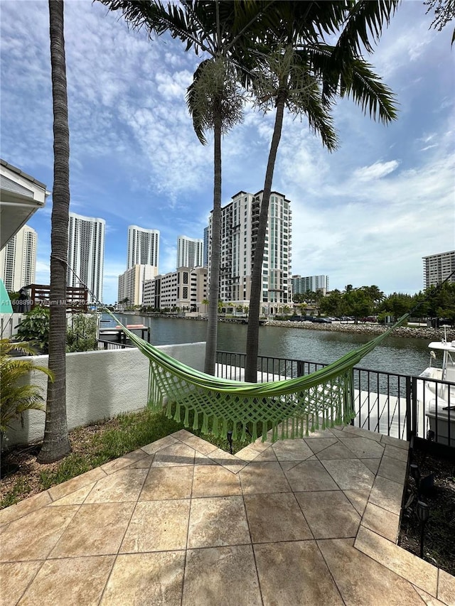 330 Poinciana Dr Unit 1002, Sunny Isles Beach, FL 33160 - view of patio / terrace featuring a water view