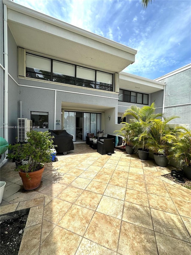 330 Poinciana Dr Unit 1002, Sunny Isles Beach, FL 33160 - back of house featuring a patio and stucco siding
