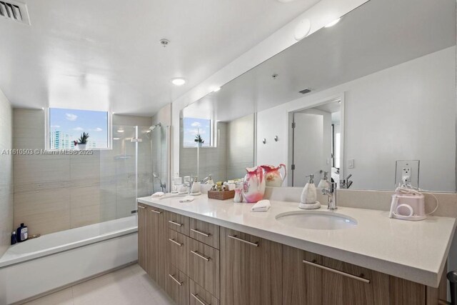 bathroom featuring vanity and enclosed tub / shower combo