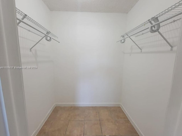 walk in closet featuring tile floors