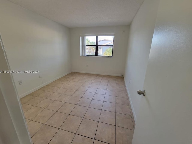 empty room with light tile floors