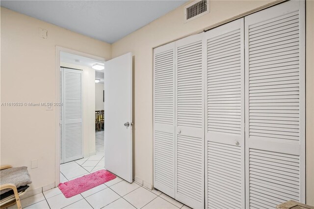 hall with light tile patterned flooring