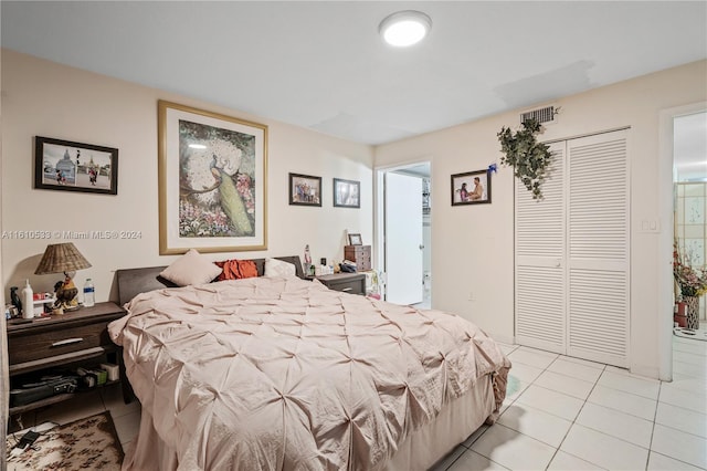 bedroom featuring a closet and light tile patterned floors