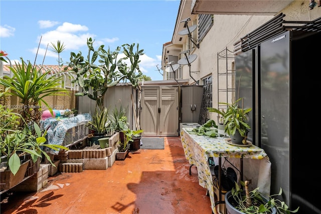 view of patio / terrace featuring a storage unit