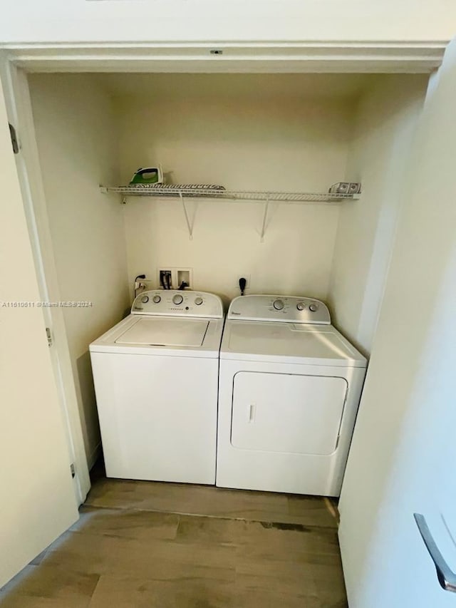 laundry area featuring separate washer and dryer, hardwood / wood-style flooring, hookup for an electric dryer, and hookup for a washing machine