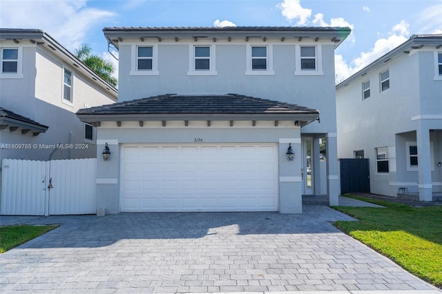 mediterranean / spanish-style home with a garage