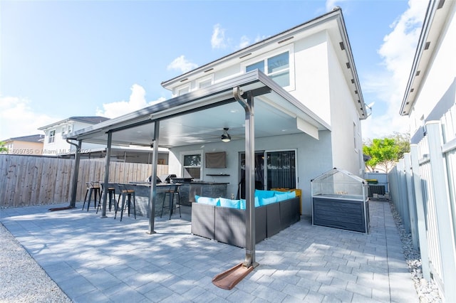 view of patio featuring ceiling fan, an outdoor bar, and outdoor lounge area