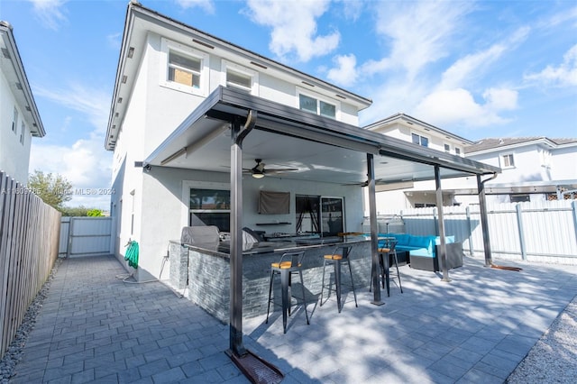 exterior space with ceiling fan, an outdoor bar, a patio, and outdoor lounge area