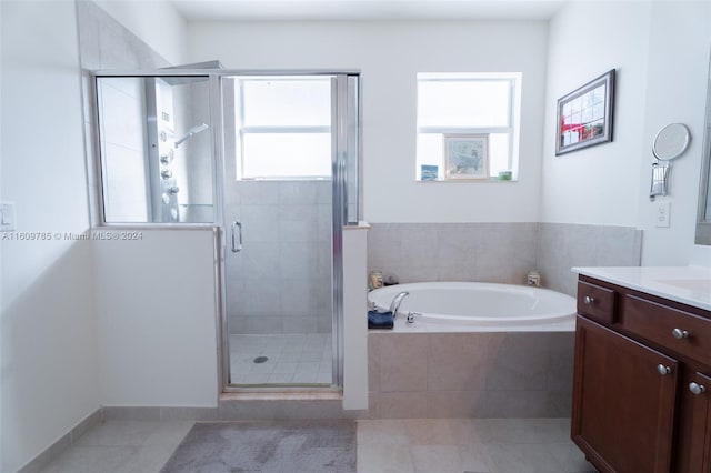 bathroom featuring vanity, tile patterned flooring, and plenty of natural light