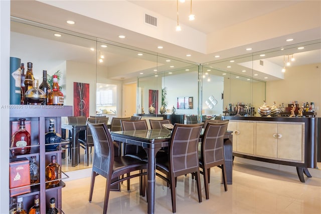 dining room featuring bar and light tile patterned floors