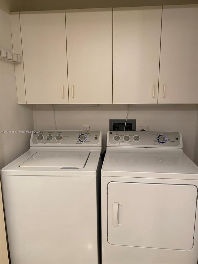 laundry area with cabinets and washer and clothes dryer