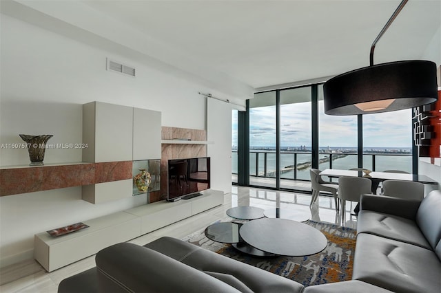 living room with a fireplace and a wall of windows