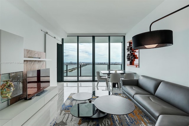 living room featuring a water view and floor to ceiling windows