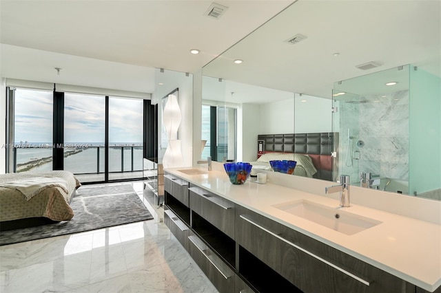 bathroom featuring vanity, a water view, and a shower with door