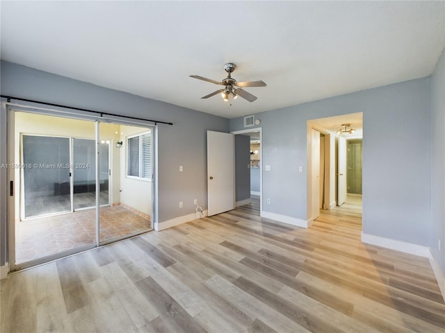 unfurnished bedroom with ceiling fan and light hardwood / wood-style flooring