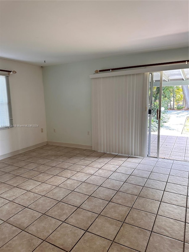 spare room with light tile floors