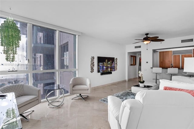 living room with ceiling fan and expansive windows