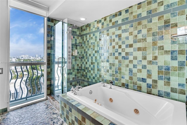 bathroom with expansive windows and independent shower and bath