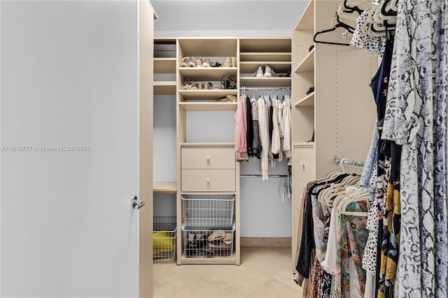 spacious closet with light tile patterned flooring