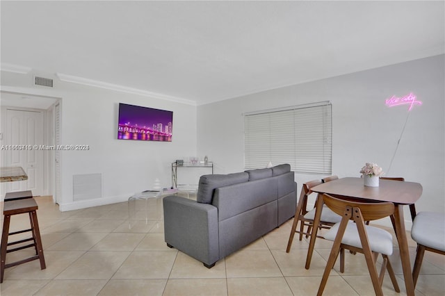 living room with light tile floors and crown molding