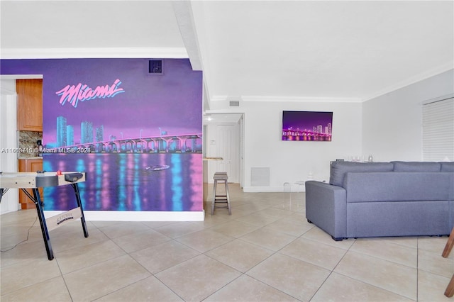 living room with tile floors and ornamental molding