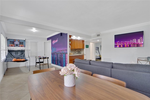 dining room featuring ornamental molding and light tile floors