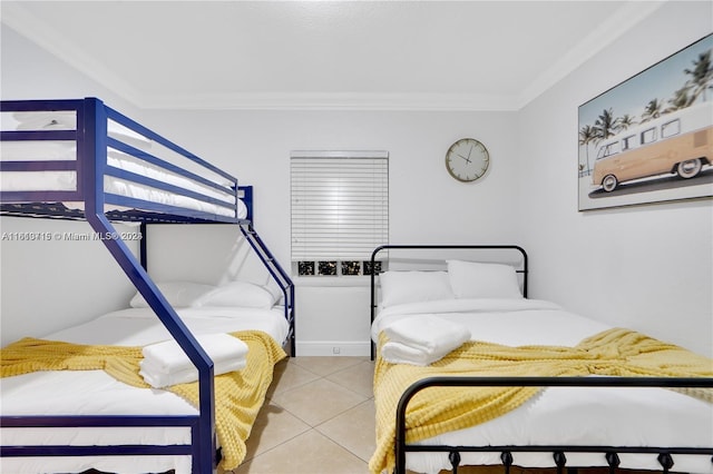 bedroom featuring crown molding and light tile flooring