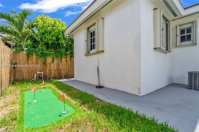 view of side of property featuring a patio area and central AC unit